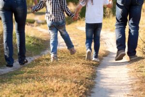 Family walking on dirt path